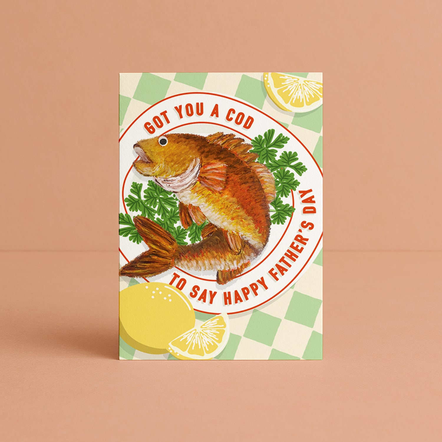 A Father's Day greeting card with a cream background, with light blue wavy stripes representing ocean waves, and an illustration of an orange fish emerging from a blue envelope. The text reads the clever pun 'Got you this cod to say Happy Father's Day'. 